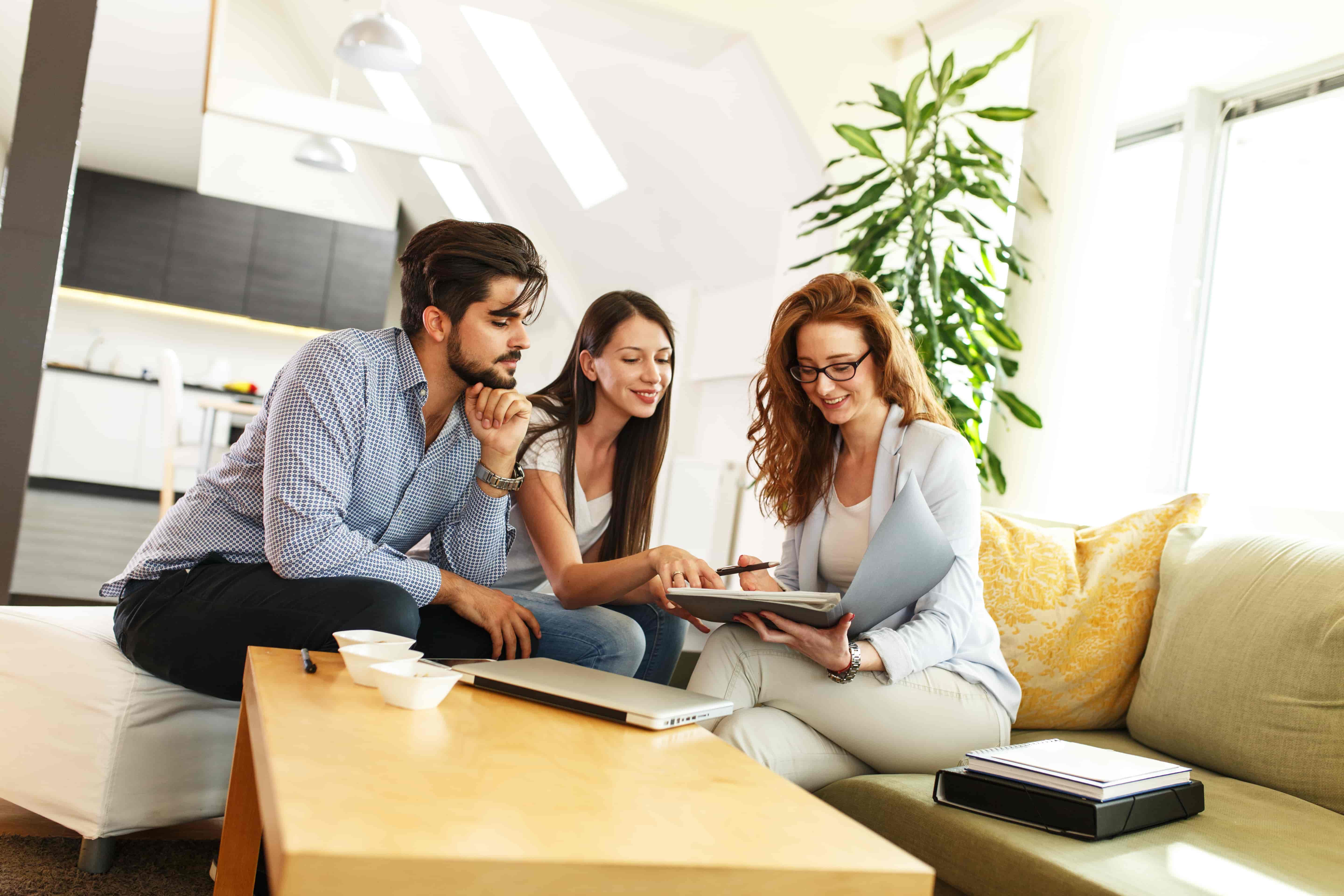 Female Real Estate agent offer home ownership and life insurance to young couple