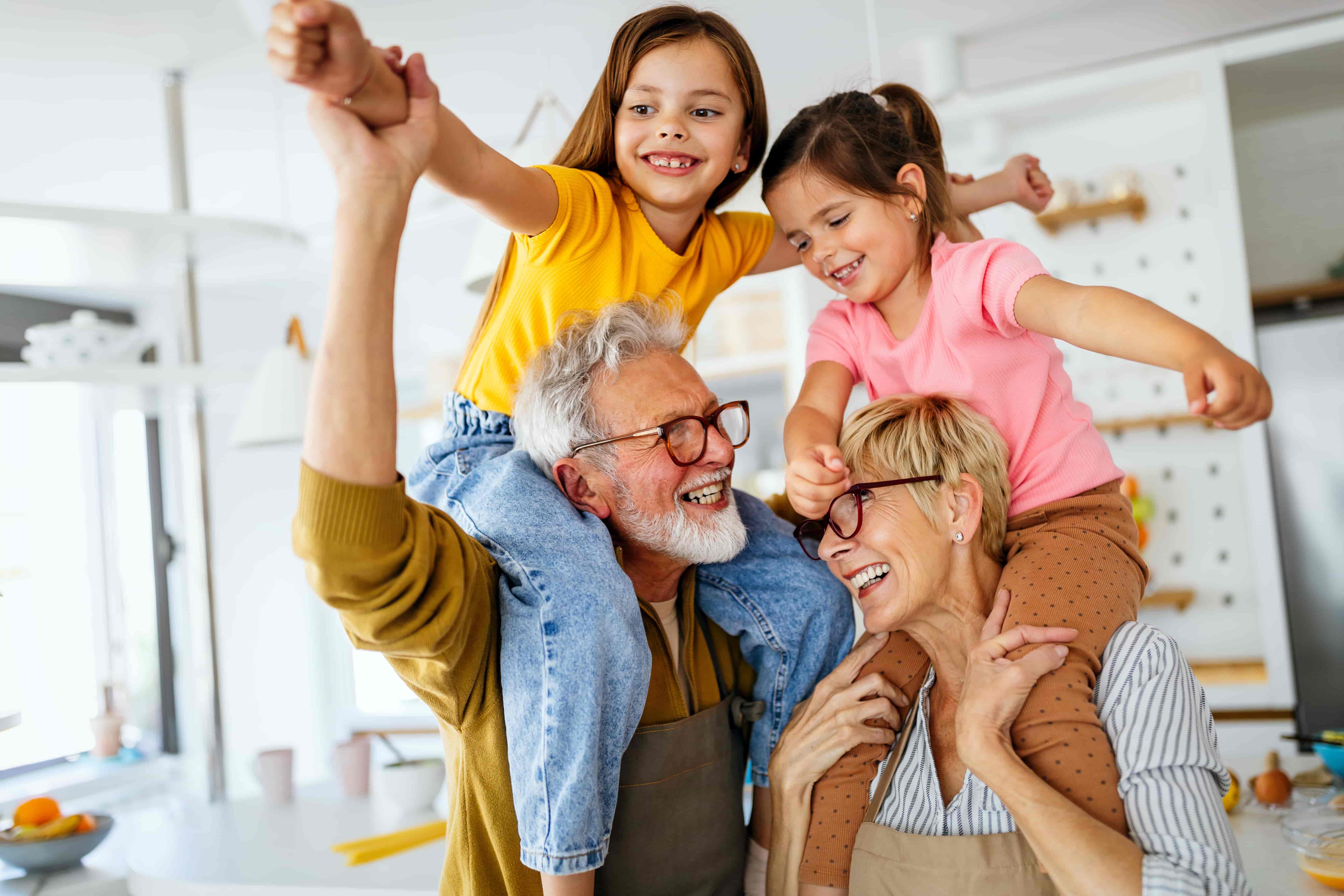 Grand parents carrying their grand-daughters