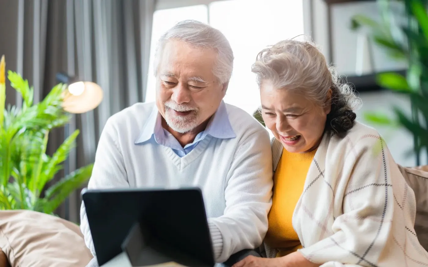 Retired Senior couple sitting on a sofa couch